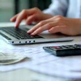 Hands processing payroll data